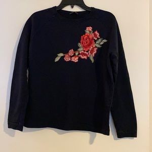 navy blue sweater with flower stitch detailing